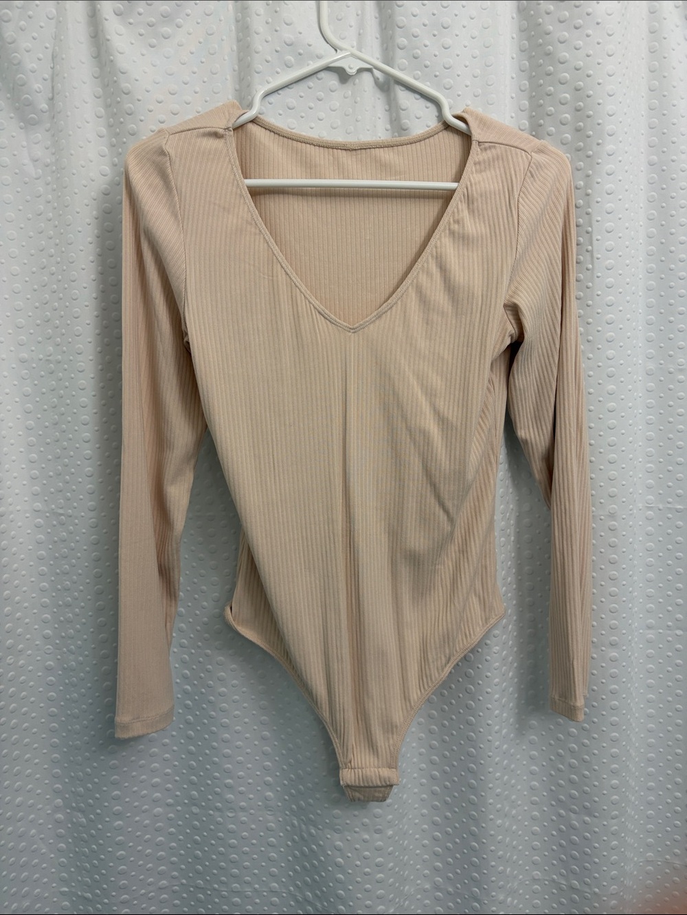 Beige/Peach Ribbed V-Neck Long Sleeve Bodysuit. Never worn